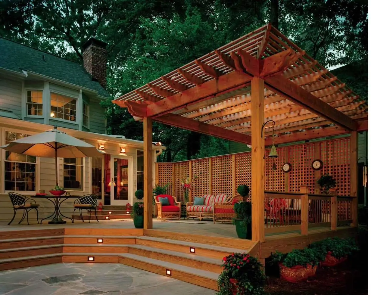 Deck with engineered pergola cover lit at dusk