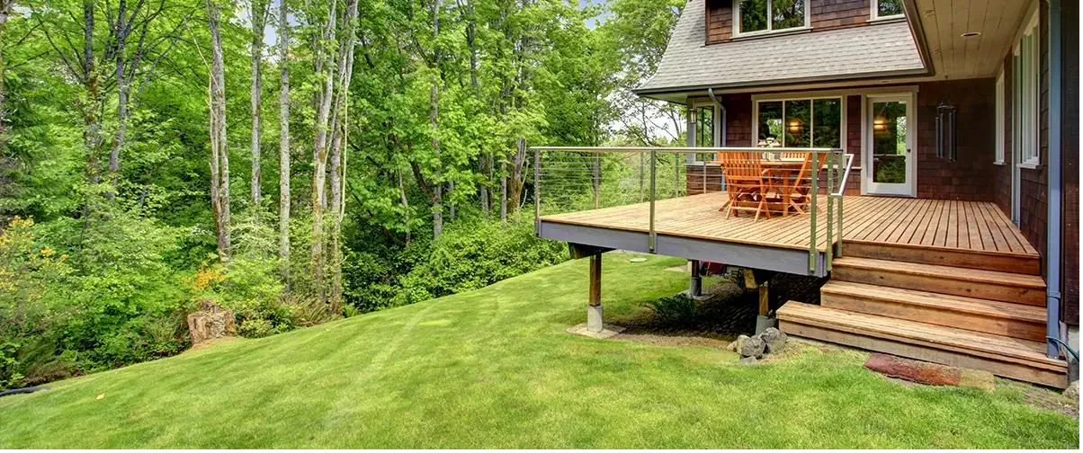 Elevated hillside deck on sloped lawn